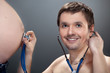 Man listening pregnant belly