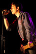 Bass Player Singing with a Microphone