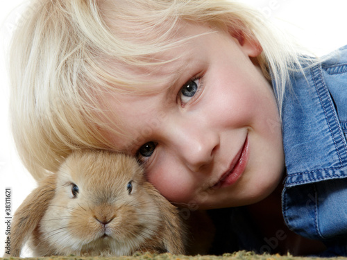 Foto: Little girl is huddling up to her cute bunny Little girl is huddling up to her cute bunny