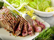 sliced steak with balsamic vinegar and green salad