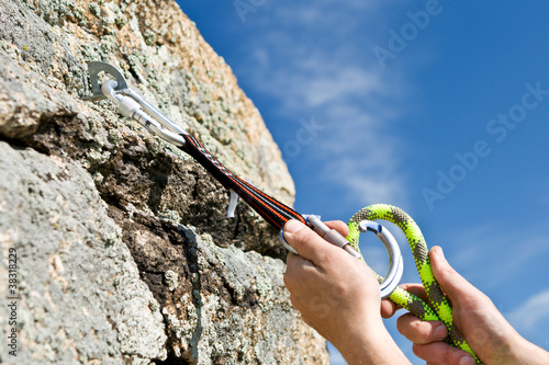 Photo: The sportsman hangs up carbine and guy-rope in rock The sportsman hangs up carbine and guy-rope in rock