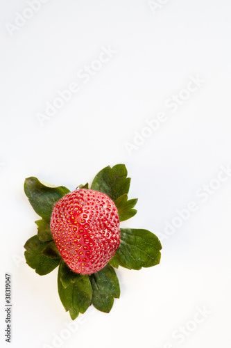 Photo: Strawberry from Above with Green Leaves Strawberry from Above with Green Leaves