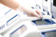 Photo: Scientist, DNA copy, white gloves, distant shot Scientist, DNA copy, white gloves, distant shot