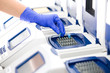 Photo: Scientist with DNA copying, Real-time cycler, wide Scientist with DNA copying, Real-time cycler, wide