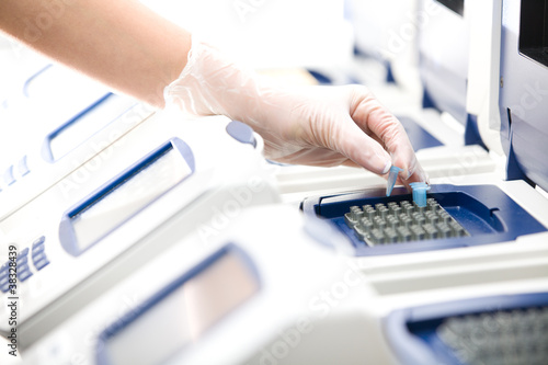 Photo: Scientist, DNA copy, white gloves, distant shot Scientist, DNA copy, white gloves, distant shot