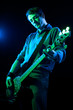Photo: Man Playing Electric Bass on Black Background Man Playing Electric Bass on Black Background