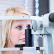 pretty, young female patient having her eyes examined