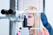 pretty, young female patient having her eyes examined