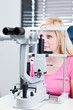 pretty, young female patient having her eyes examined