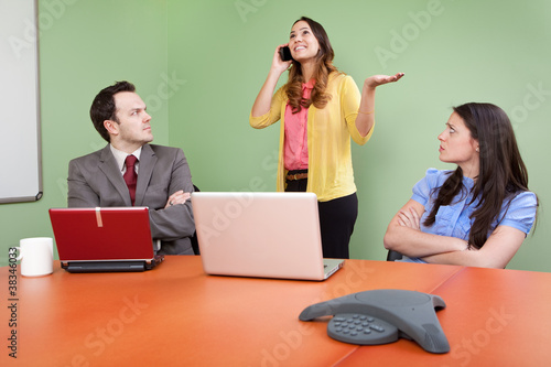 Photo: Rude colleague disturbing meeting by talking on Smartphone Rude colleague disturbing meeting by talking on Smartphone