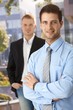 Smiling businessmen outside of office Smiling businessmen outside of office