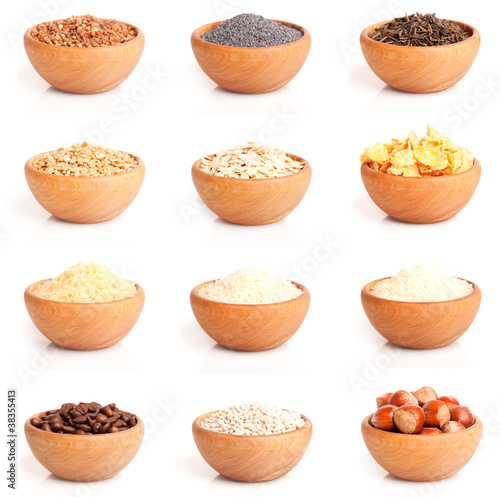 Photo: assortment of nuts and grits in the wooden bowl. assortment of nuts and grits in the wooden bowl.