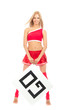 Foto: Cheerleader woman pointing her finger at a board Cheerleader woman pointing her finger at a board