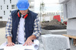 Construction worker checking plans