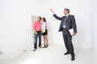 Couple being shown around property by estate-agent