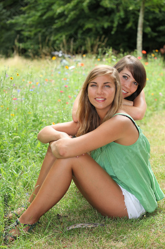 Photo: Friends sitting in a field Friends sitting in a field