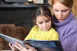 Photo: Mother and daughter reading book together Mother and daughter reading book together