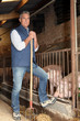 Photo: Farmer standing with rake in hand Farmer standing with rake in hand