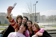 Teens taking a picture of themselves with a mobile phone
