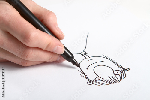 Photo: Human Hand drawing caricature of man Human Hand drawing caricature of man