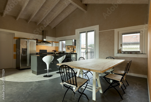 Photo: interior, view of dining table and kitchen interior, view of dining table and kitchen
