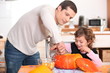 Father and daughter carving pumpkins