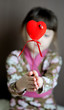 Photo: Heart shaped toy with ladybird in child's hands Heart shaped toy with ladybird in child's hands