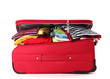 Сlosed red suitcase with clothing isolated on a white
