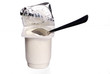 open yoghurt pot with teaspoon isolated open yoghurt pot with teaspoon isolated