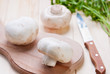 Photo: Mushrooms champignons on cutting board. Mushrooms champignons on cutting board.