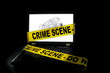 Photo: Laptop computer with crime scene tape across it Laptop computer with crime scene tape across it