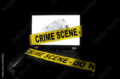 Photo: Laptop computer with crime scene tape across it Laptop computer with crime scene tape across it