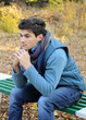 Young man sitting in park.