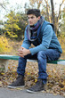 Young man sitting in park.