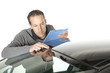 Photo: Insurance agent looking at a car Insurance agent looking at a car