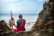 Maasai sitting by the ocean on the beach