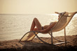 The girl in a hat having a rest on seacoast