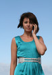 Young woman talking on mobile phone looking straight to camera