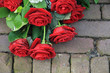 Red rose sympathy flower arrangement on pavement Red rose sympathy flower arrangement on pavement