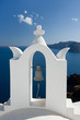 See view through white church arch and bell Santorini Greece .