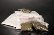 Cocaine and marihuana in packages on grey background