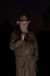 man with cowboy hat, long leather coat and riot gun