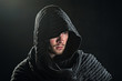 A bearded man in a hood.