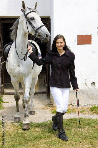 Photo: equestrian with horse at stable equestrian with horse at stable