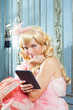 blond fashion princess woman reading ebook tablet