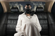 Lady in a gas mask on the back seat of limousine