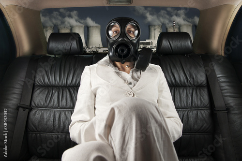 Photo: Lady in a gas mask on the back seat of limousine Lady in a gas mask on the back seat of limousine