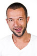 Portrait of a young man with his tongue, white background