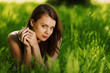 brunette lying on green grass