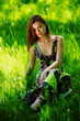 brunette sitting on green grass